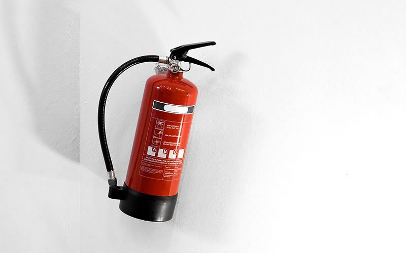 Red ABC fire extinguisher for home use in Singapore.